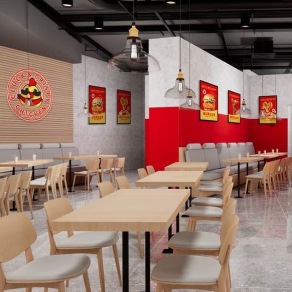Modern Cluck & Crispy Chicken fast-food restaurant interior with wooden tables, chairs, and red wall accents.