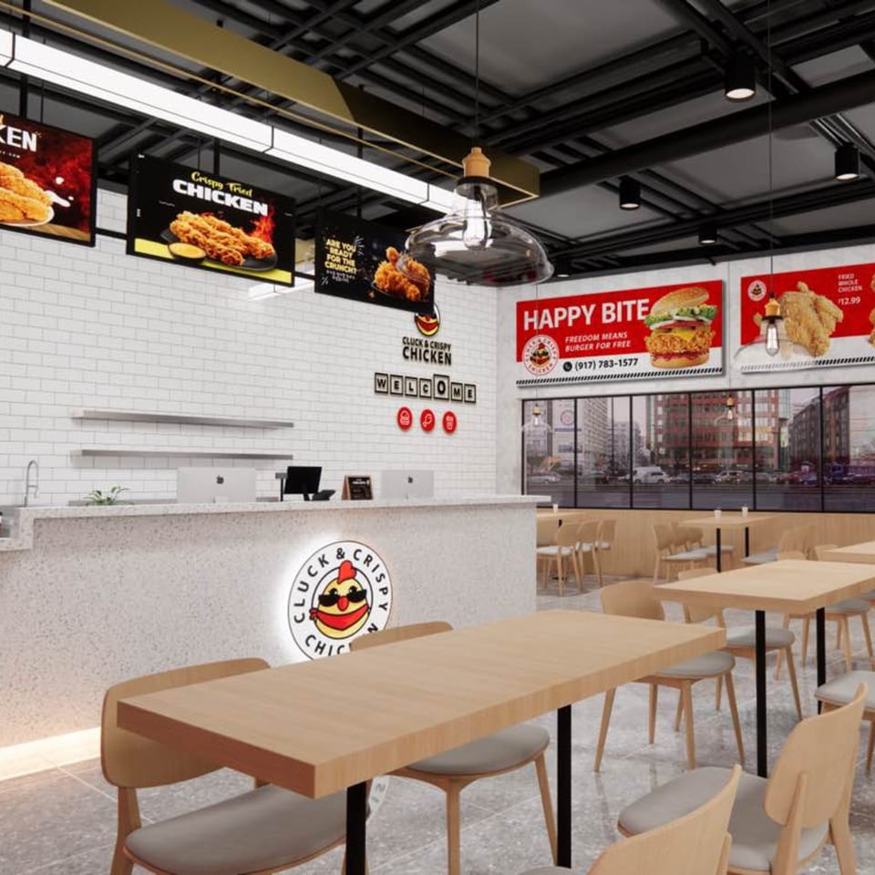 Interior of a Cluck & Crispy Chicken fast-food restaurant with a counter, dining tables, and menu boards.